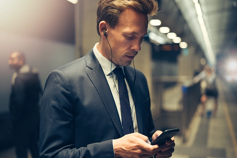 Business man with earphones and phone